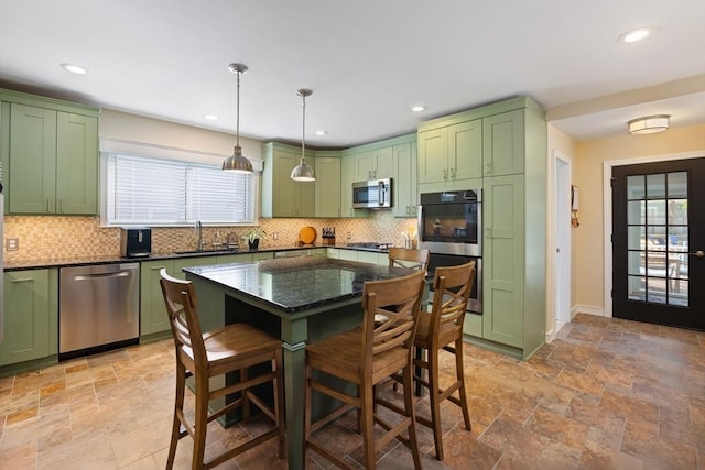 kitchen with appliances with stainless steel finishes, green cabinetry, and a sink