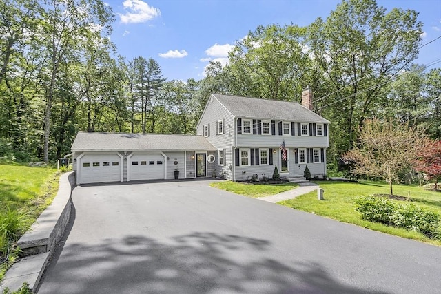 40 Abbott Ln, Chelmsford, MA 01824 - colonial-style house featuring a garage, asphalt driveway, a chimney, and a front yard