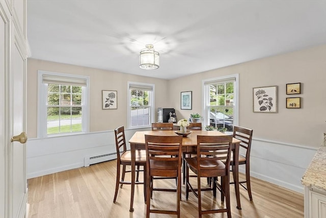 40 Abbott Ln, Chelmsford, MA 01824 - dining area featuring a baseboard heating unit, light wood finished floors, and healthy amount of natural light