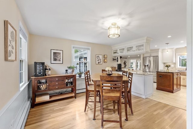 40 Abbott Ln, Chelmsford, MA 01824 - dining area with light wood finished floors and a baseboard radiator