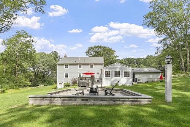 40 Abbott Ln, Chelmsford, MA 01824 - rear view of property featuring a yard, a fire pit, a chimney, a wooden deck, and a patio
