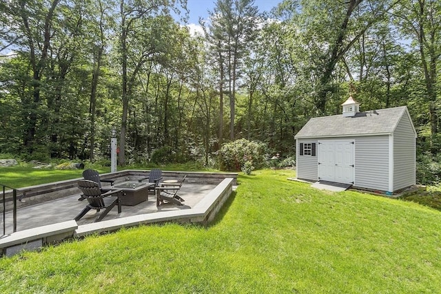 40 Abbott Ln, Chelmsford, MA 01824 - view of green lawn featuring a fire pit and an outdoor structure