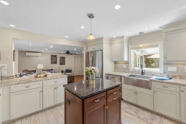 40 Abbott Ln, Chelmsford, MA 01824 - kitchen featuring appliances with stainless steel finishes, a wall mounted air conditioner, open floor plan, a ceiling fan, and pendant lighting