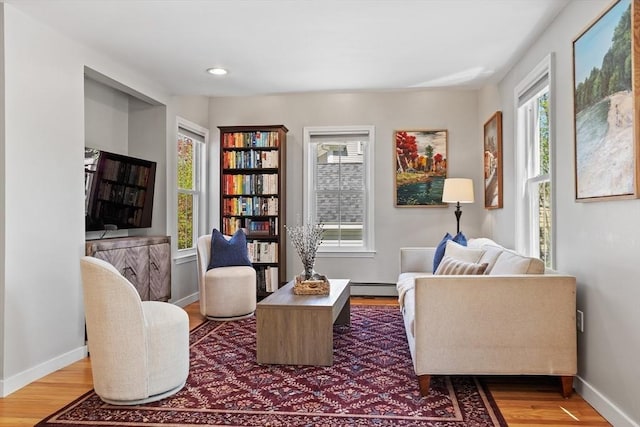 sitting room featuring baseboards, a baseboard radiator, wood finished floors, and recessed lighting