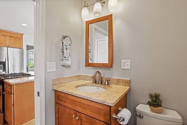 half bathroom with vanity and toilet
