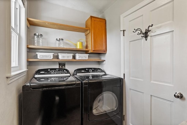 laundry room with cabinet space and separate washer and dryer