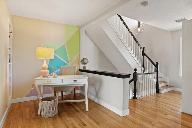 interior space with baseboards and wood finished floors