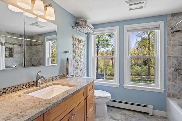 bathroom featuring visible vents, vanity, toilet, decorative backsplash, and a baseboard heating unit
