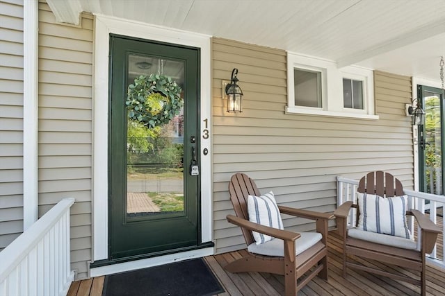 view of exterior entry featuring covered porch