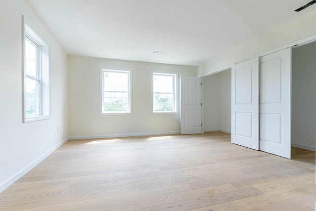 unfurnished bedroom with light wood-type flooring