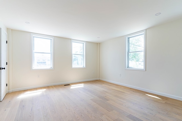 empty room with light hardwood / wood-style flooring