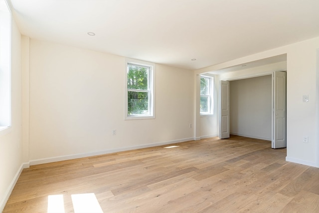 spare room with light hardwood / wood-style flooring