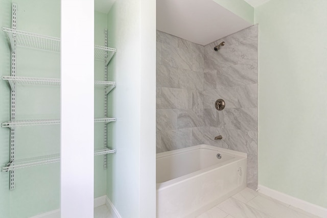 bathroom with tile patterned floors and tiled shower / bath