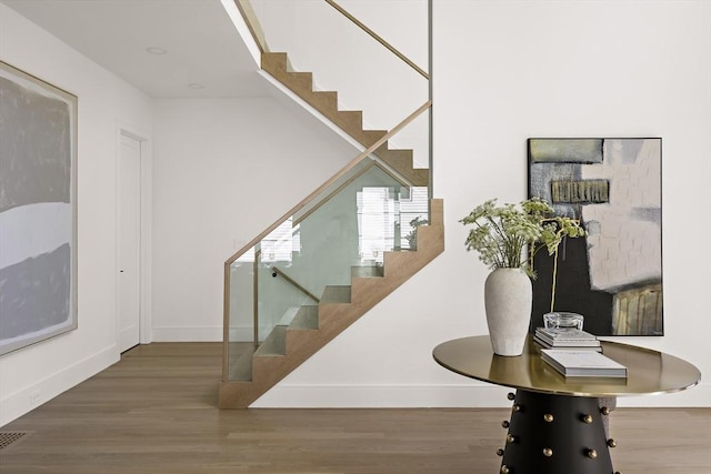 staircase featuring wood-type flooring