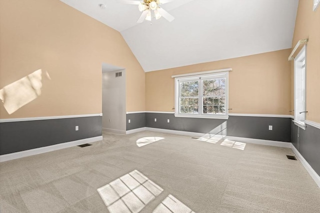 carpeted empty room featuring visible vents, ceiling fan, and baseboards