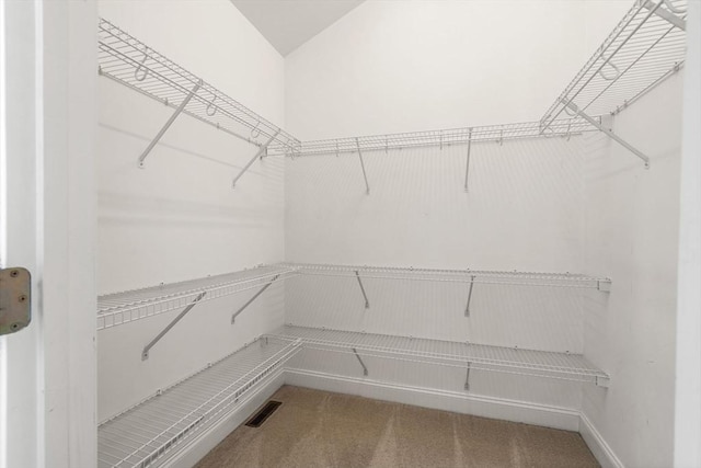 walk in closet featuring carpet floors and visible vents