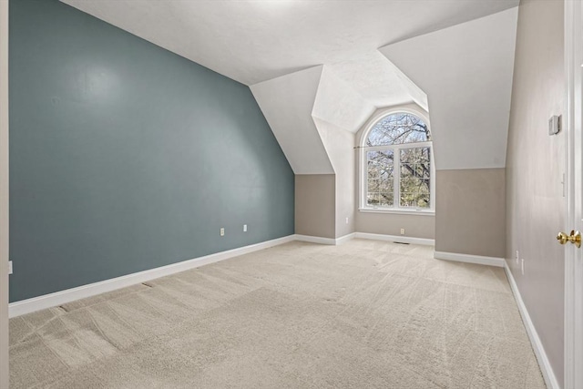 additional living space with lofted ceiling, carpet flooring, and baseboards