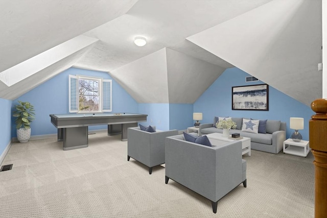 interior space featuring light colored carpet, visible vents, vaulted ceiling, and baseboards