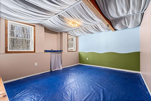 interior space with finished concrete flooring and baseboards