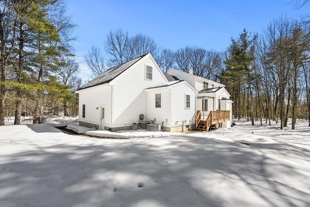 exterior space with a chimney and a wooden deck