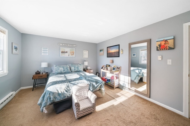 bedroom with baseboard heating and light carpet