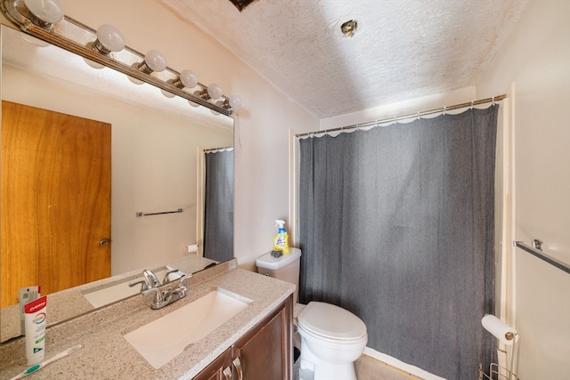 bathroom with vanity, tile patterned floors, a textured ceiling, and toilet