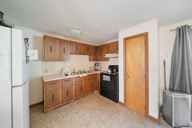 kitchen featuring decorative backsplash, white fridge, black / electric stove, and sink