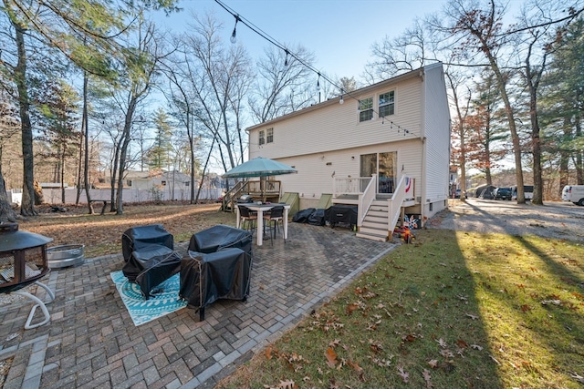 rear view of house with a yard and a patio