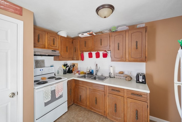 kitchen with backsplash, sink, and white appliances