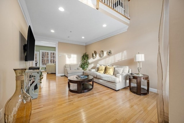 living room featuring ornamental molding and light wood-type flooring