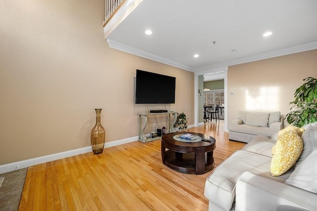 living room with crown molding and hardwood / wood-style floors