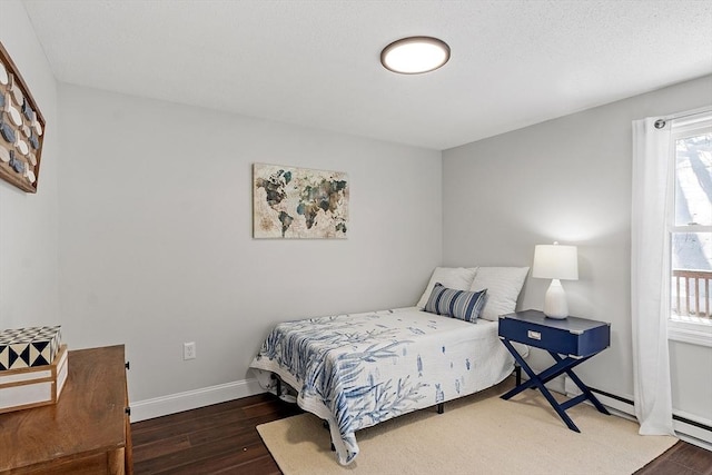 bedroom with baseboards and dark wood finished floors