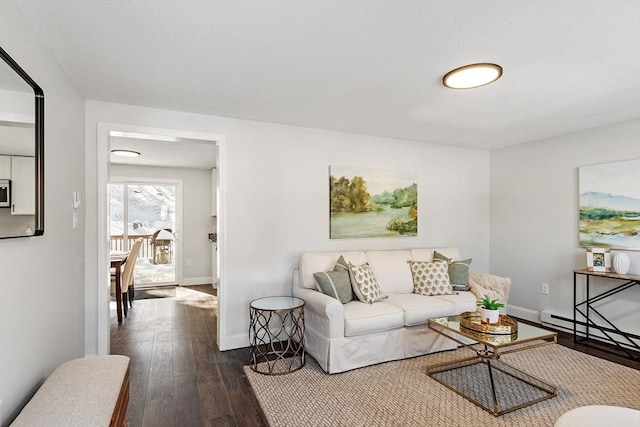 living room featuring dark wood-type flooring and baseboards