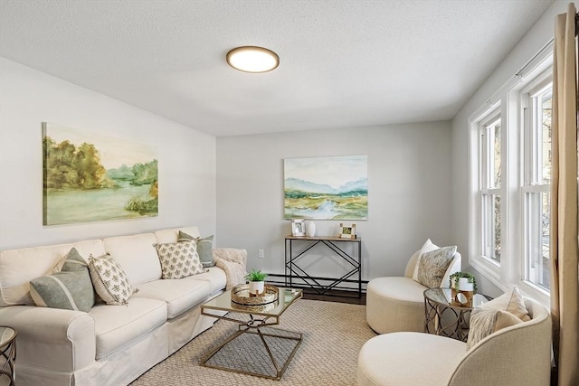 living area with a textured ceiling, baseboard heating, and wood finished floors