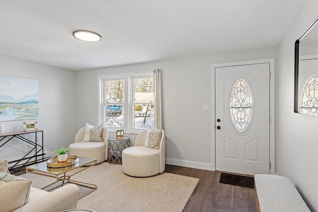 foyer entrance featuring dark wood-style floors and baseboards