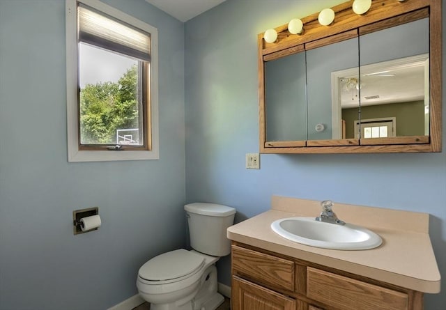 30 Pheasant Ln, Pembroke, MA 02359 - half bathroom featuring toilet, plenty of natural light, vanity, and baseboards