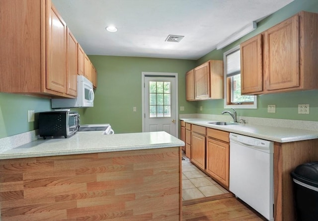 30 Pheasant Ln, Pembroke, MA 02359 - kitchen featuring white appliances, a sink, light countertops, and a peninsula