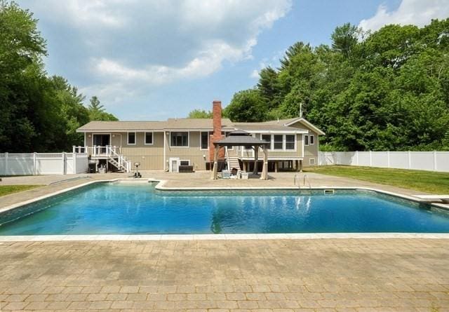 30 Pheasant Ln, Pembroke, MA 02359 - view of swimming pool with stairway, a patio area, a wooden deck, and a diving board
