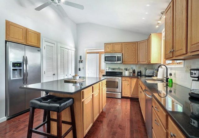 30 Pheasant Ln, Pembroke, MA 02359 - kitchen featuring appliances with stainless steel finishes, a sink, a kitchen bar, dark wood-type flooring, and decorative backsplash