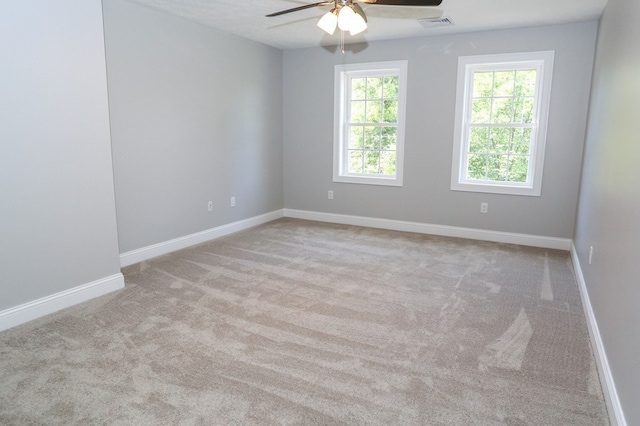 unfurnished room featuring ceiling fan and light carpet