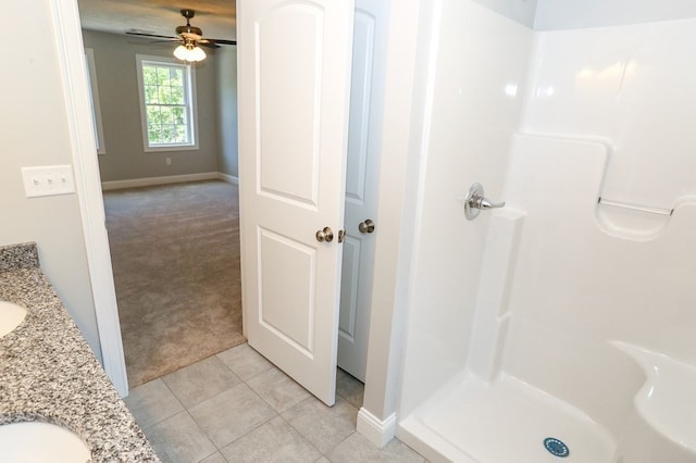 bathroom featuring dual vanity, ceiling fan, a shower, and tile patterned flooring