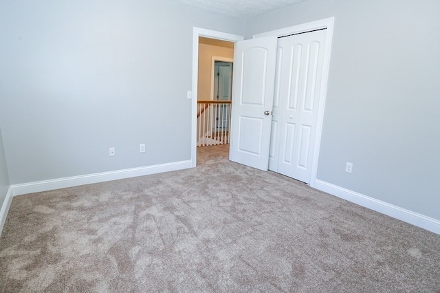 unfurnished bedroom with carpet flooring and a closet