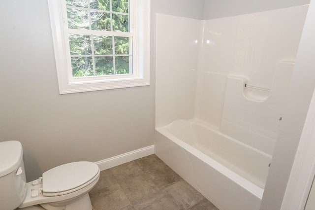 bathroom with shower / tub combination, tile patterned flooring, and toilet