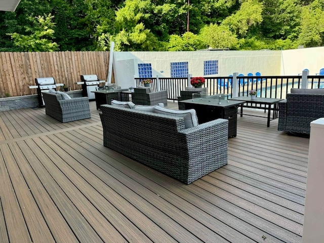 wooden deck featuring an outdoor hangout area and grilling area