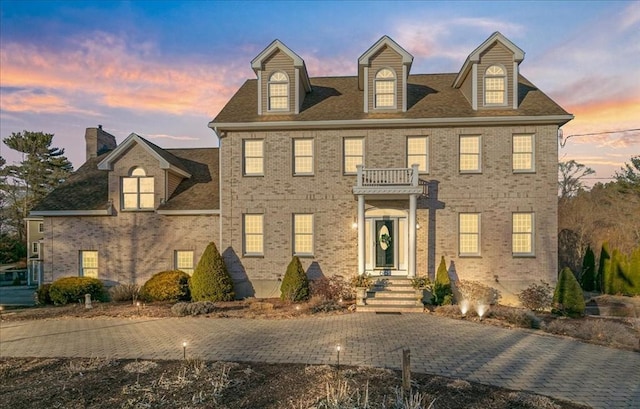 colonial-style house with brick siding