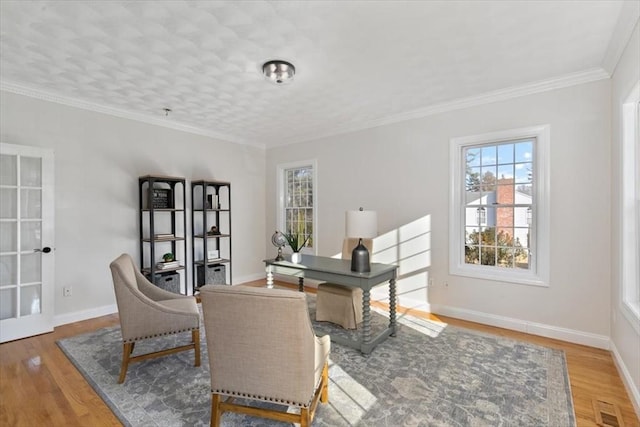 office area with wood finished floors, baseboards, and ornamental molding