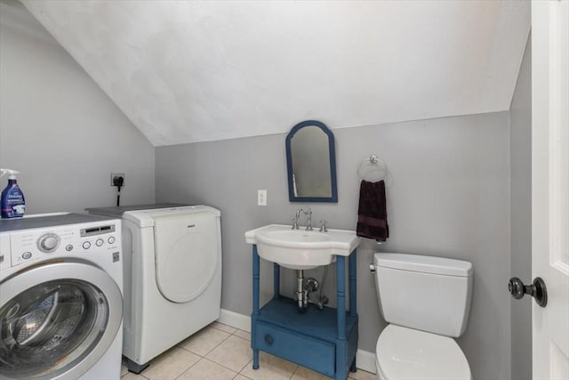 laundry room with washer and clothes dryer, laundry area, baseboards, and light tile patterned flooring