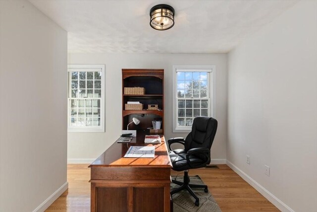 office featuring light wood-type flooring and baseboards