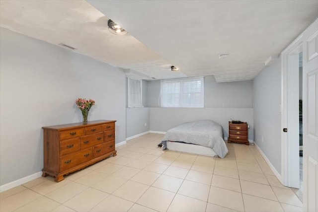 bedroom with light tile patterned floors, visible vents, and baseboards