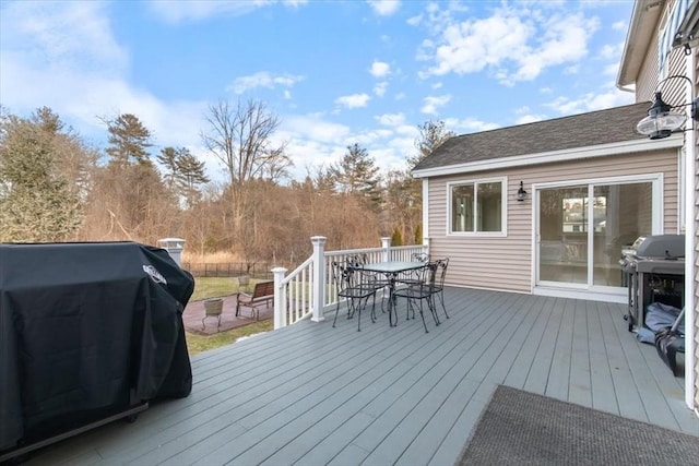 deck with area for grilling and outdoor dining space